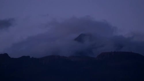 Dark Mountain Range Silhouetted Against Night Sky