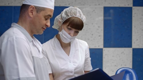 Dentist and assistant analyzing x-ray at the dental clinic