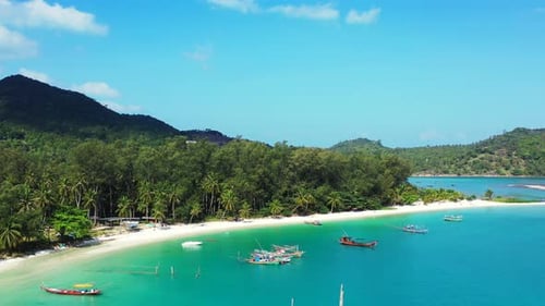 Tropical birds eye tourism shot of a white sand paradise beach and turquoise sea background in high