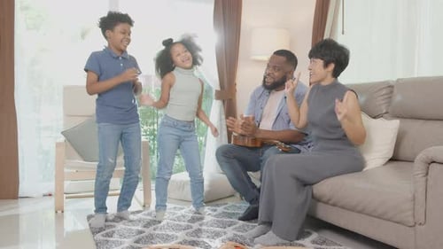 Happy Family Dancing and Singing at Home