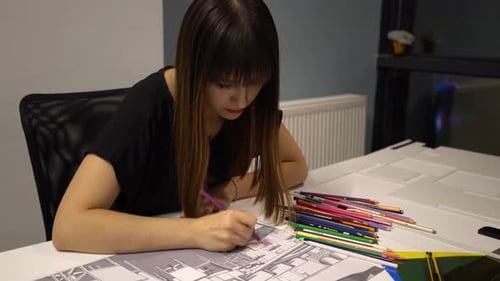 Woman Coloring Architectural Drawing at Workplace