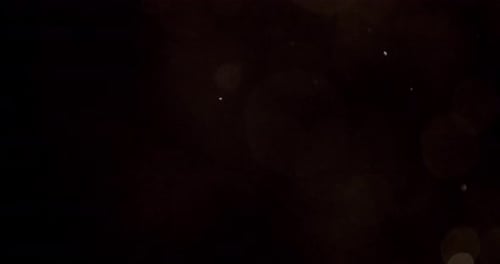 Bokeh Lights and Particles on Dark Background