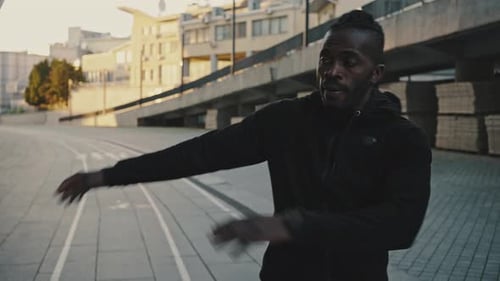 Active African American Athlete Taking Break in Run Training Breathing and Stretching His Body