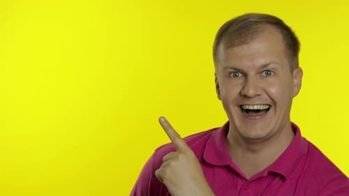 Smiling Man Pointing to the Left on Yellow