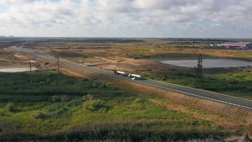 Big cars are driving along the road. Water tanks. Top view. High quality 4k footage.
