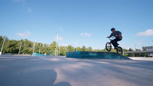 BMX Bike Rider Performing Trick in Skate Park