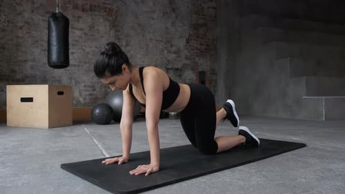 Woman Exercising Indoors on Yoga Mat