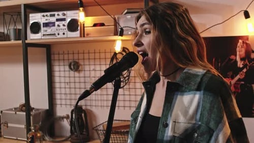 Attractive Rock Girl Singing In Microphone