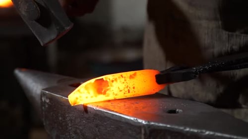 Blacksmith Forging Hot Metal on Anvil