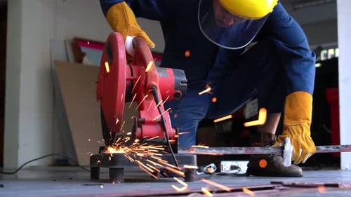Metalworker Cuts Material With Chop Saw Indoors