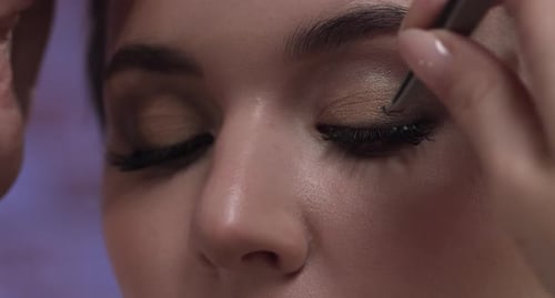 Makeup Artist Applies False Eyelashes in Detailed Close-Up