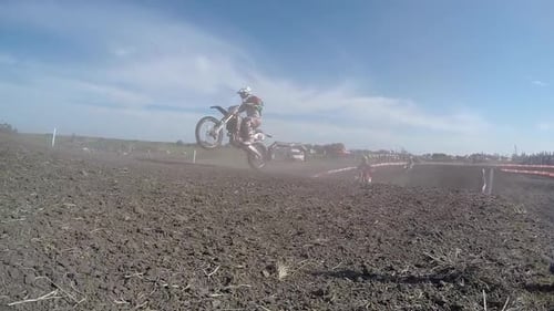 Motocross Racers Jump on Dirt Course