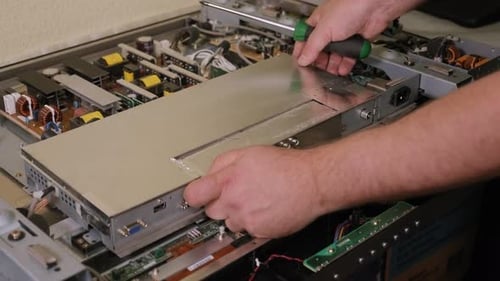 Closeup of a Technician Repairing a Modern LSD TV in a Service Center