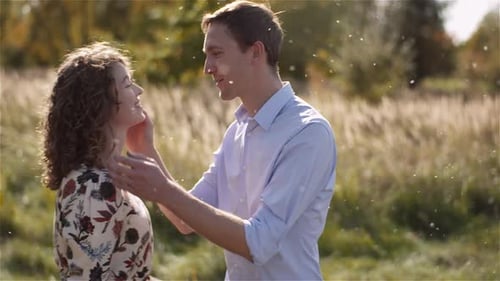 Young Couple in Love Walking on Meadow in Summer - Togetherness Concept