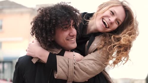 Passionate Young Couple Kissing And Embracing Spinning Around Outdoor In The City