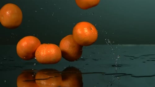 Tangerines Falling and Splashing in Slow Motion