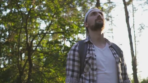 A Young Man Walks in the Woods.