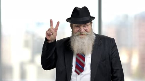 Senior Man Gives Peace Sign in City Setting