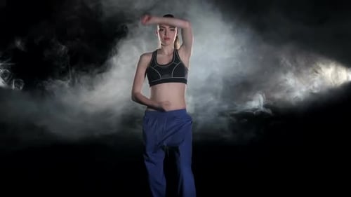 Young Woman Practicing Martial Arts in Studio