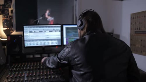Music Producer Mixing Audio in Recording Studio