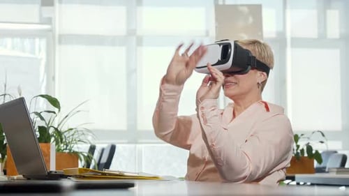 Woman Interacts with VR Headset in Office Setting