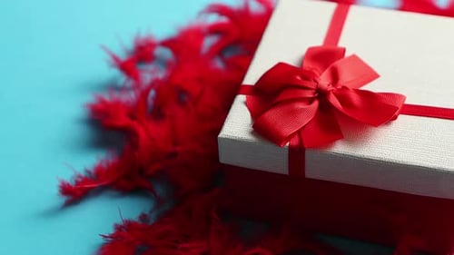 Gift Box with Red Ribbon on Blue Background