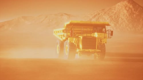 Large Yellow Mining Dump Truck Driving Through a Dusty Desert