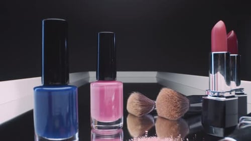 Colorful Assortment of Beauty Products on Mirrored Surface