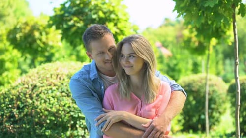 Romantic Couple Embracing in a Green Urban Park