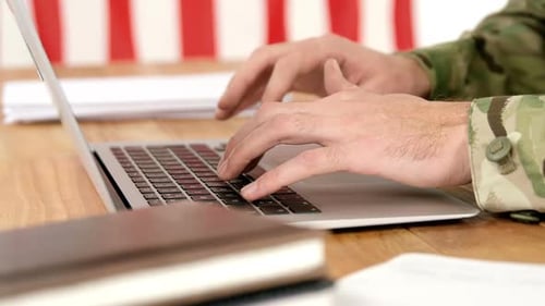 Hands Type at a Laptop with American Flag