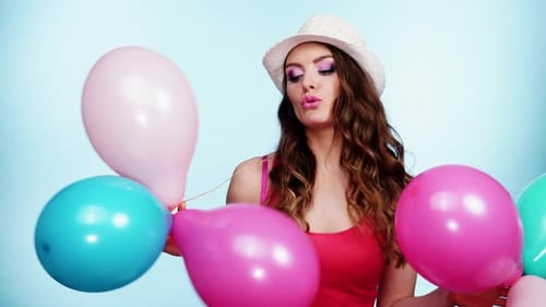 Woman Holding Balloons Celebrating Birthday Occasion