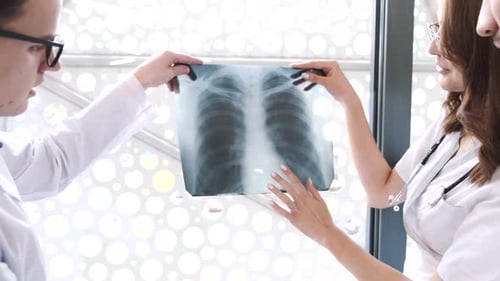 Doctors Examining Chest X-Ray in Hospital