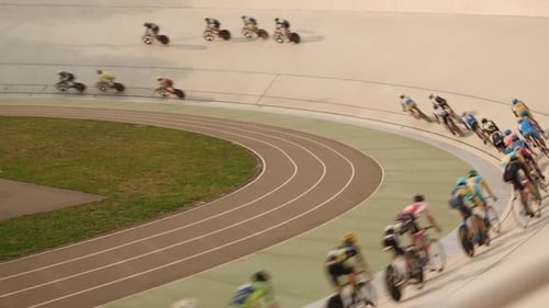 Cycling track pursuit race. Professional cyclists racing on velodrome.