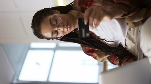 Young African American Holding Credit Card Using Laptop and Buying Online Close Up
