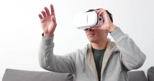 Young Adult Using Virtual Reality Headset Indoors