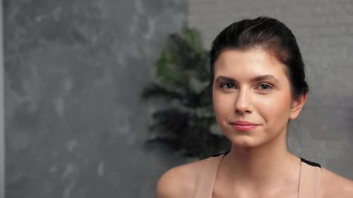 Woman Drinks Water from Reusable Blue Bottle