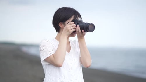 Young Woman Taking Photos at the Beach