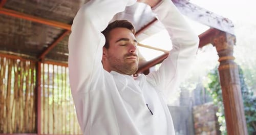 Man Meditating in a Bamboo Gazebo