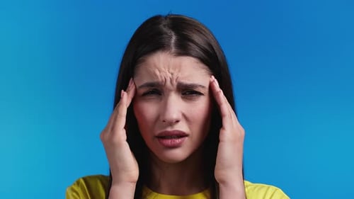 Portrait of Woman Having Headache Blue Studio Portrait