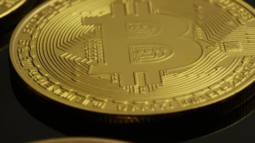 Rotating shot of Bitcoins (digital cryptocurrency) - BITCOIN