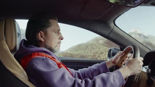 Man Driving Car Along Sunny Road