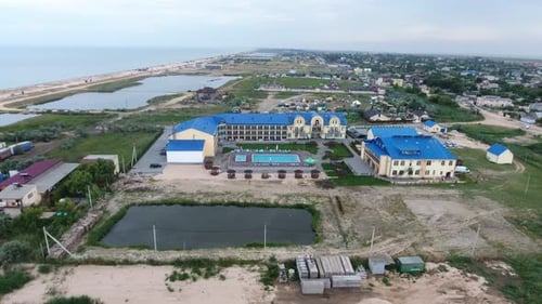 Aerial Shot of a Big Hotel Complex with a Swimming Pool on a Sea Resort in Sumer
