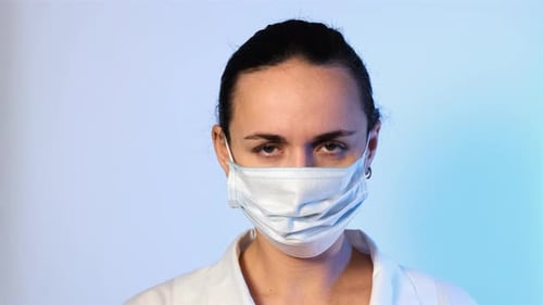 Woman Wearing Surgical Mask and Cap in Studio Shot