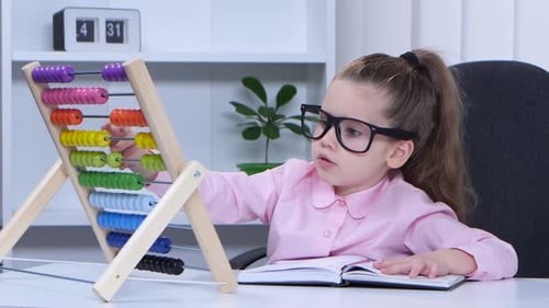 La niña dice en las cuentas y registra los datos en el propio cuaderno