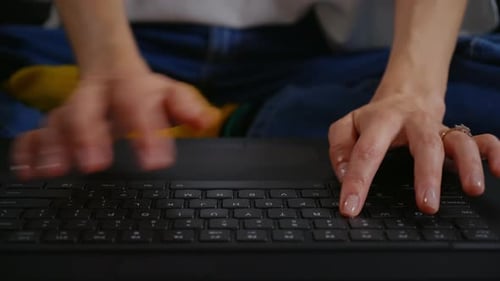 Woman's Hands Typing on Laptop Keyboard