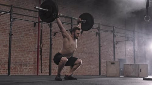Man Weightlifting Barbell in Gym with Haze