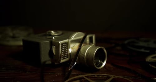 Vintage Movie Camera on Dark Wooden Table