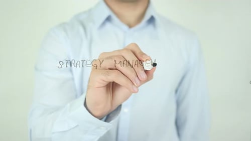 Man Writes Strategy Management on a Clear Surface