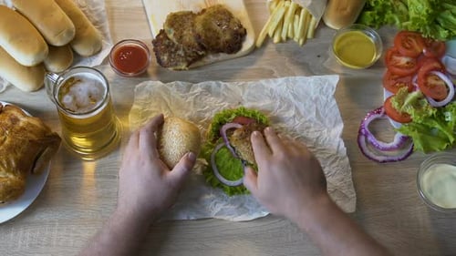 Obese Man Adding Fatty Fried Chops to His Burger, Unhealthy Eating