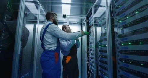 Two Men Performing Maintenance in a Data Center